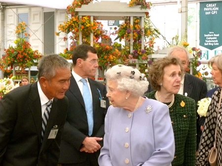 Her Majesty Queen Elizabeth II visits the gold medal winning Thai exhibit during the 2012 Chelsea Flower Show.